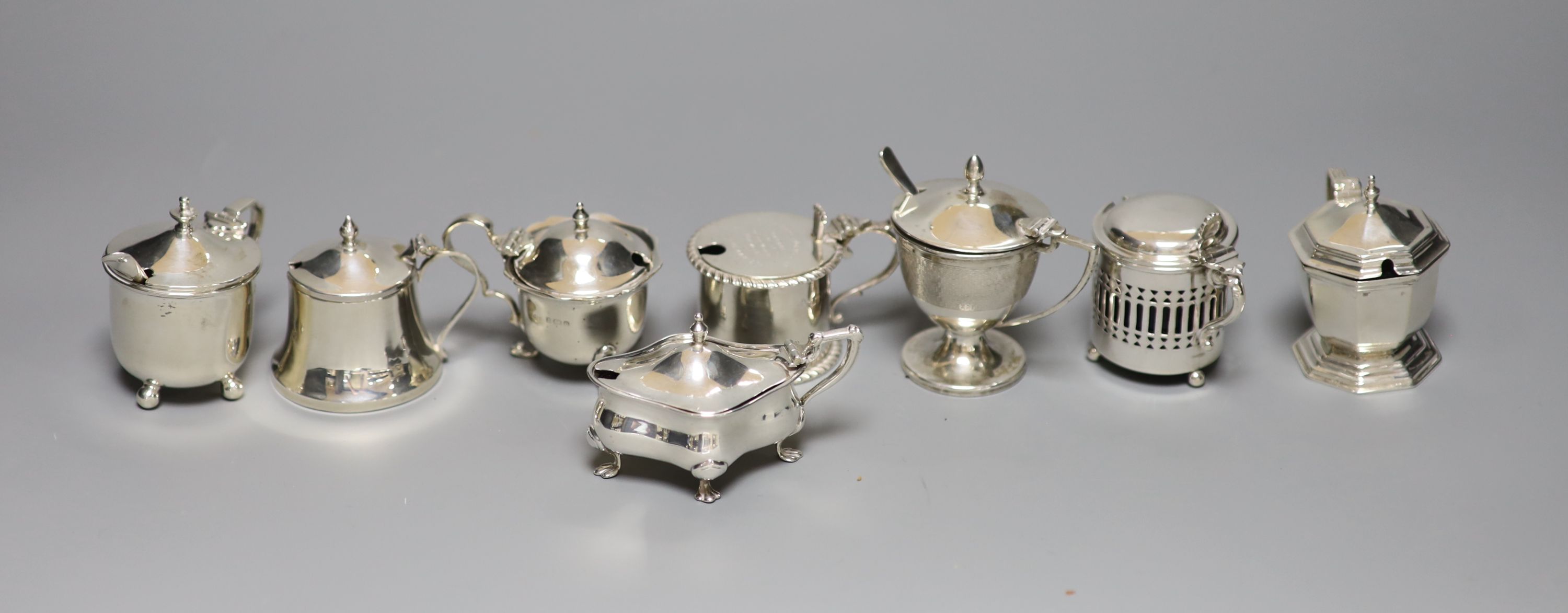 A J & J Colman Ltd presentation cylindrical silver mustard, inscribed to top and seven other silver mustards, various, 11.5oz